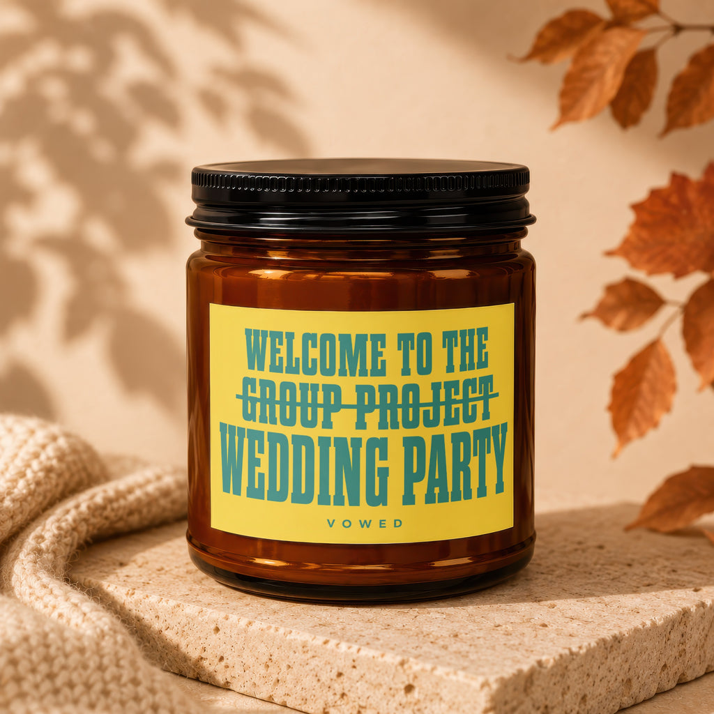 Amber jar candle with yellow label reading "Welcome to the group project wedding party Vowed."