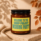 Amber jar candle with yellow label reading "Welcome to the group project wedding party Vowed."