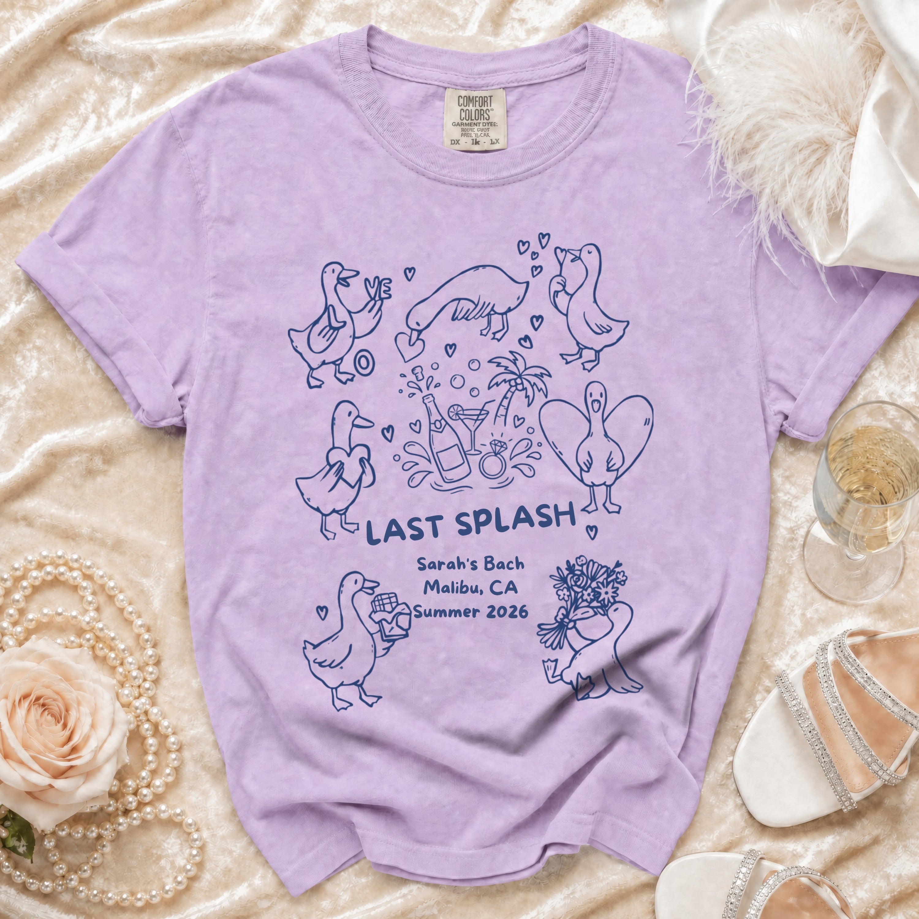 Purple t-shirt with "LAST SPLASH" text and duck illustrations for Sarah's Bach, Malibu, CA, Summer 2026.