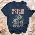 Dark blue t-shirt with "Mother of the Bride Raising Hell Not Just Her" text.