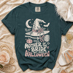 Dark teal t-shirt with "Mother of the Bride but make it Halloween" graphic.
