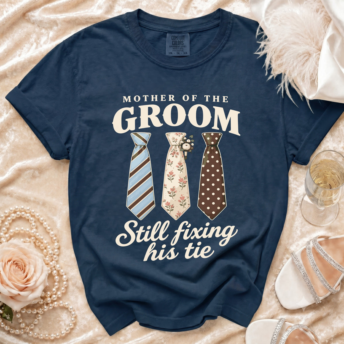 Navy t-shirt with "Mother of the Groom Still Fixing His Tie" text and three ties.