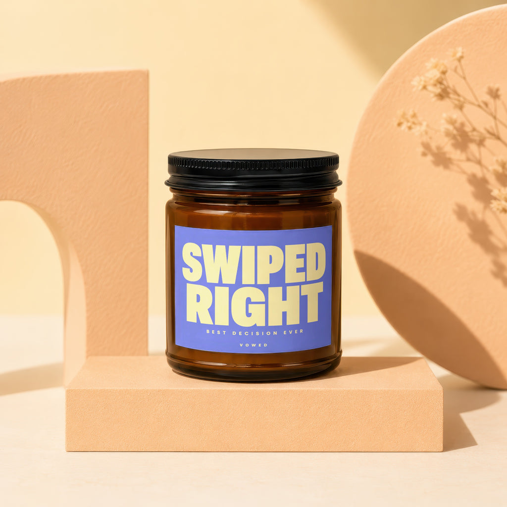 Amber glass candle with a blue label reading "SWIPED RIGHT BEST DECISION EVER VOWED".