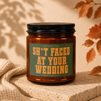 Amber candle with black lid labeled "Smells Like S*** Faced At Your Wedding".
