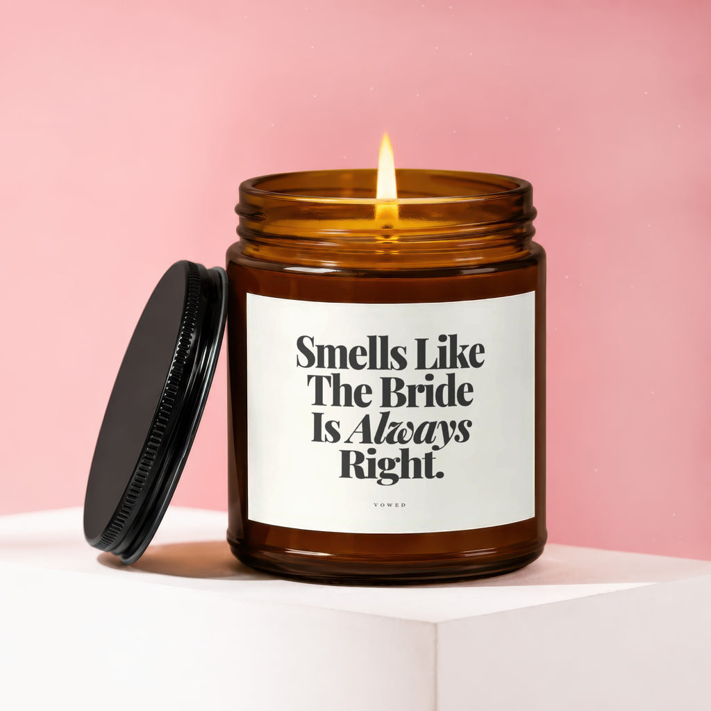 Amber jar candle with lit flame and lid reads "Smells Like The Bride Is Always Right."