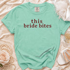 Seafoam green t-shirt with "this bride bites" printed in maroon.