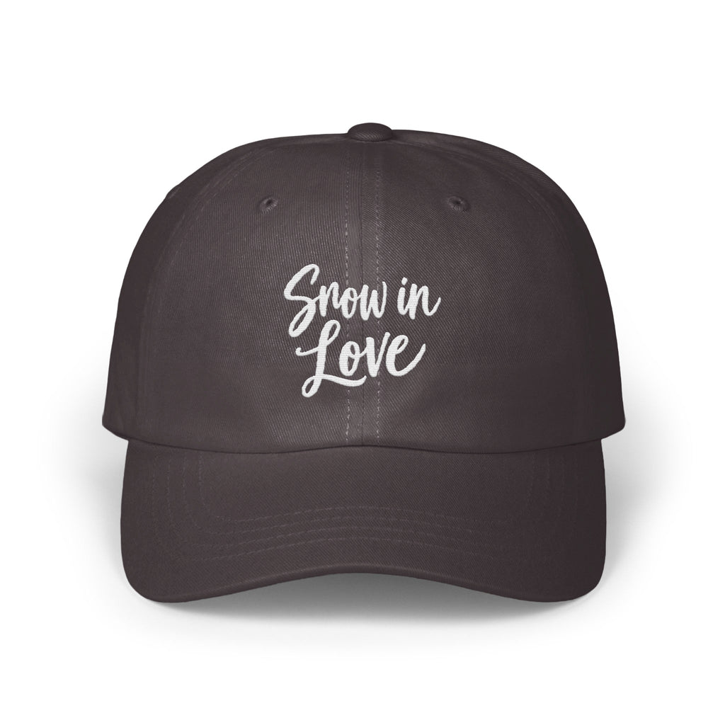 A dark gray baseball cap features white embroidered cursive text that reads Snow in Love.