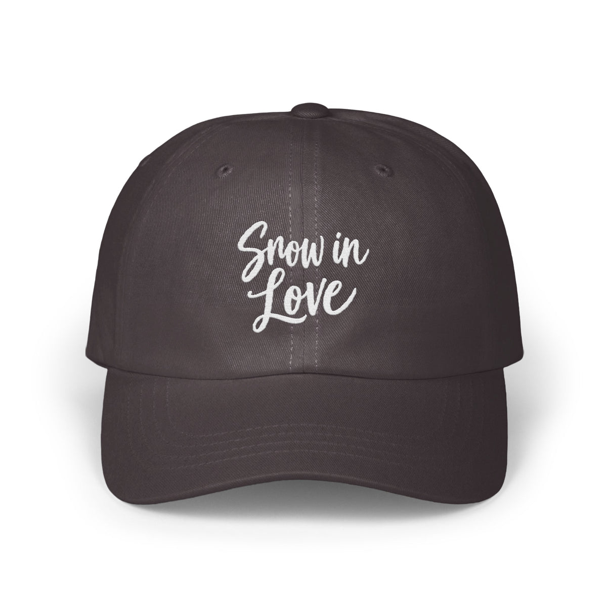 A dark gray baseball cap features white embroidered cursive text that reads Snow in Love.