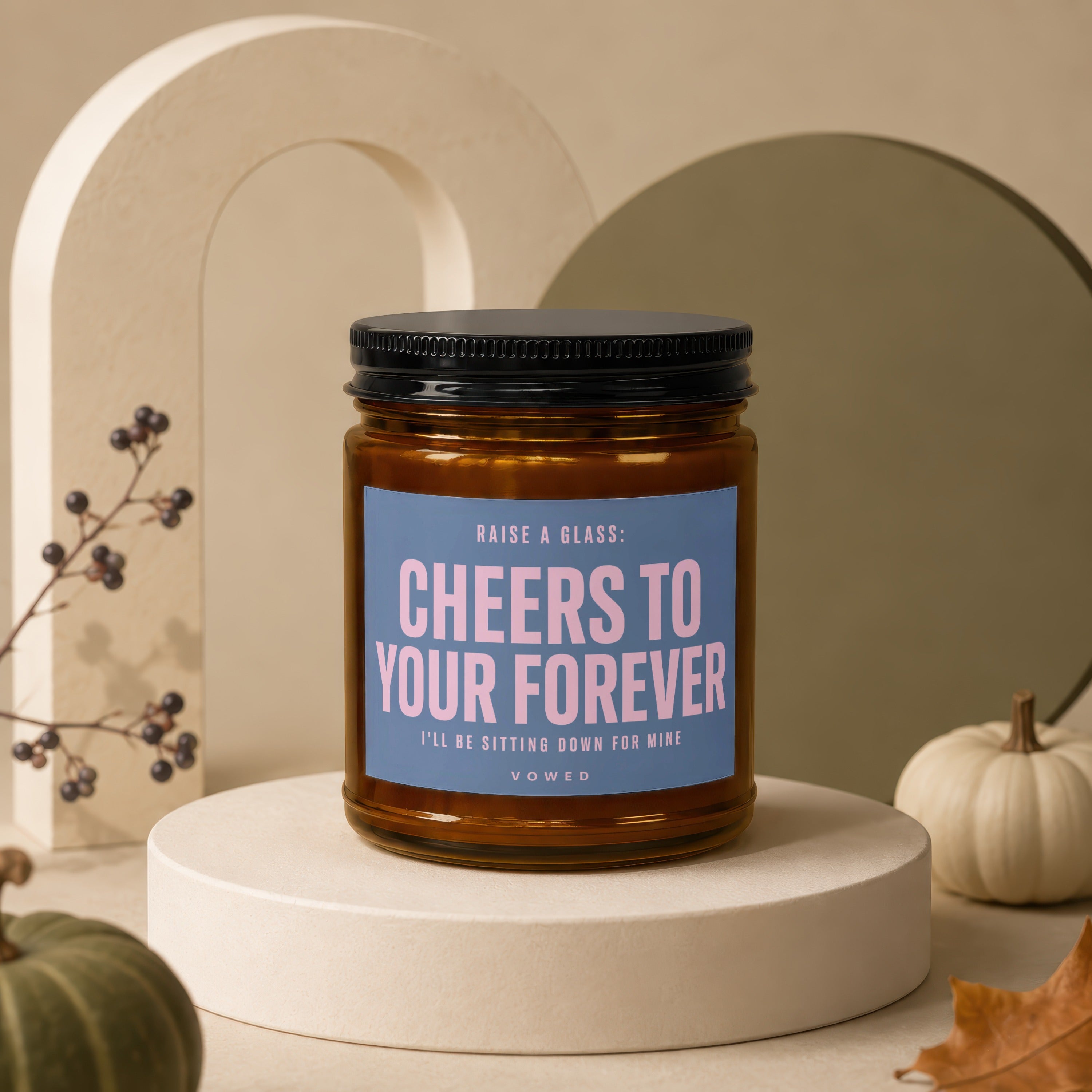 Candle with text "Cheers to your forever. I'll be sitting down for mine. Vowed."