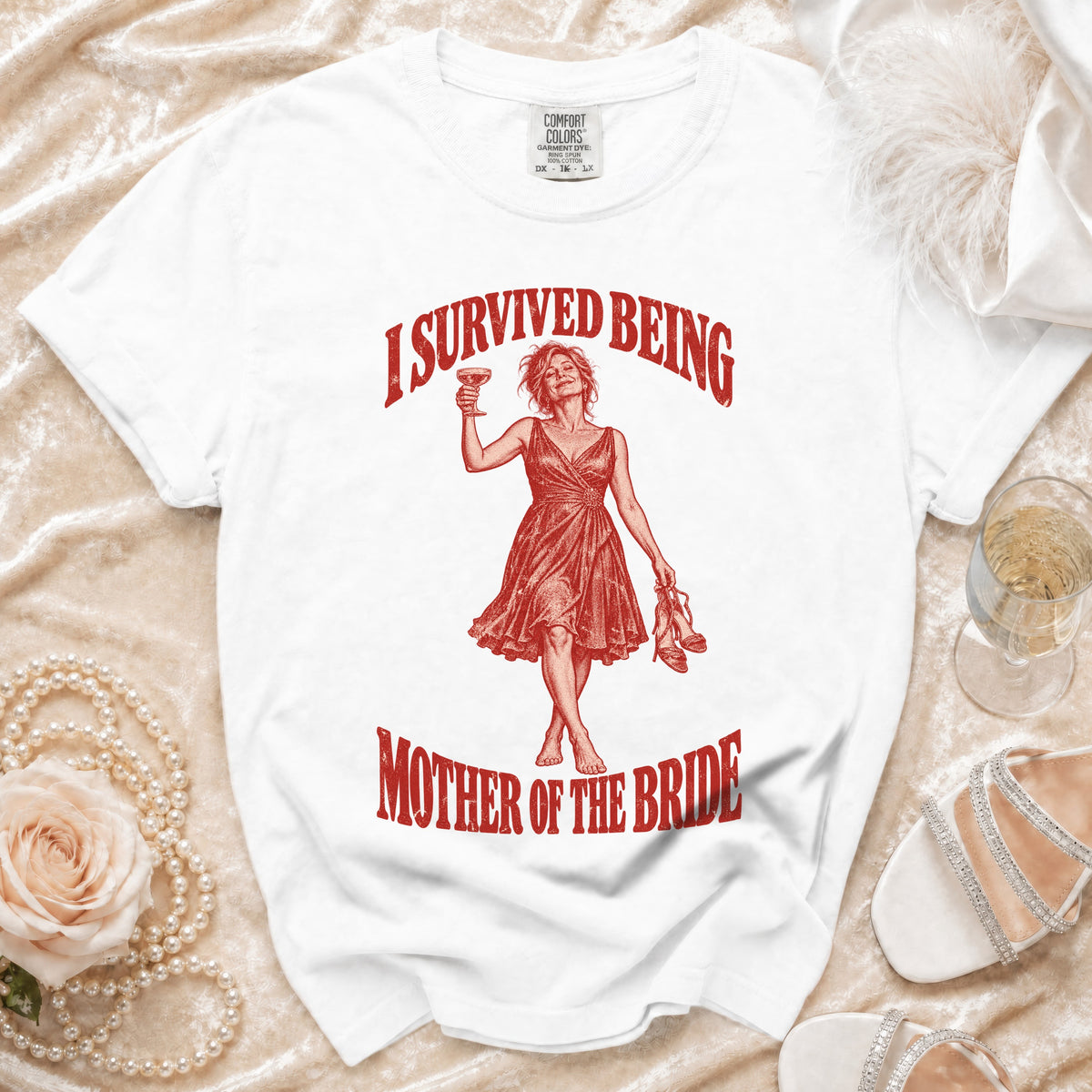 White t-shirt with "I Survived Being Mother of the Bride" graphic.