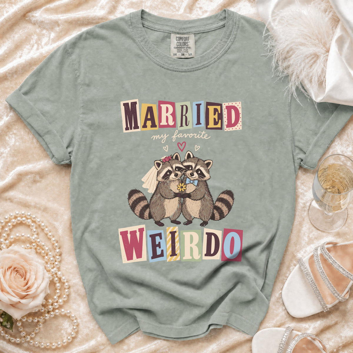 T-shirt with "MARRIED my favorite WEIRDO" and two raccoons in wedding attire.