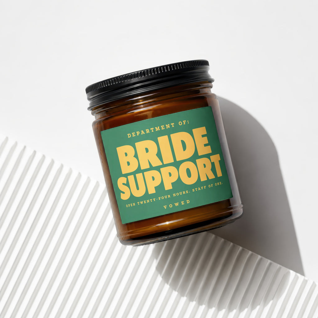 Amber jar candle labeled "Department of: Bride Support" with accompanying text.