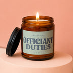 Candle with text "SMELLS LIKE OFFICIANT DUTIES VOWED" on a light green label.