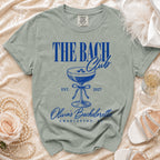 "The Bach Club" t-shirt with cocktail glass, "EST. 2027", "Olivia's Bachelorette", and "Charleston, SC".