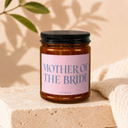 Candle with "MOTHER OF THE BRIDE" text on pink label.