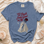 Blue t-shirt with "'Til Death Looks Good on Me" text and skeleton hand graphic.