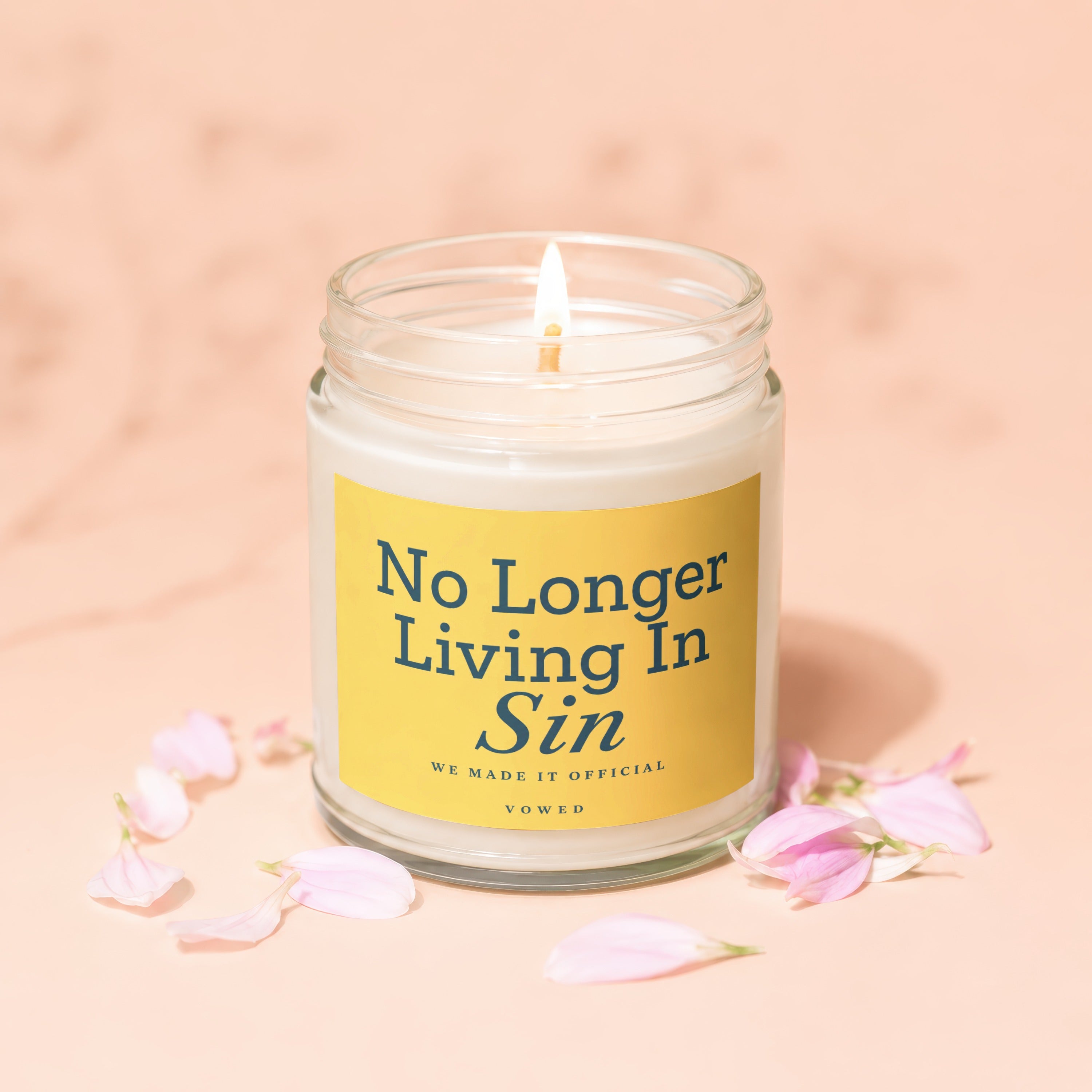 Lit candle in a jar with yellow label reading "No Longer Living In Sin."