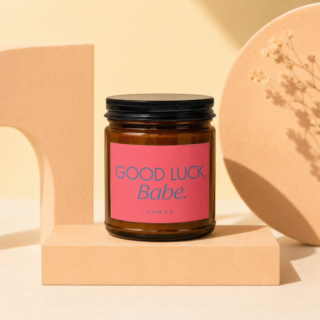 Candle with pink label "Good Luck, Babe." by Vowed.