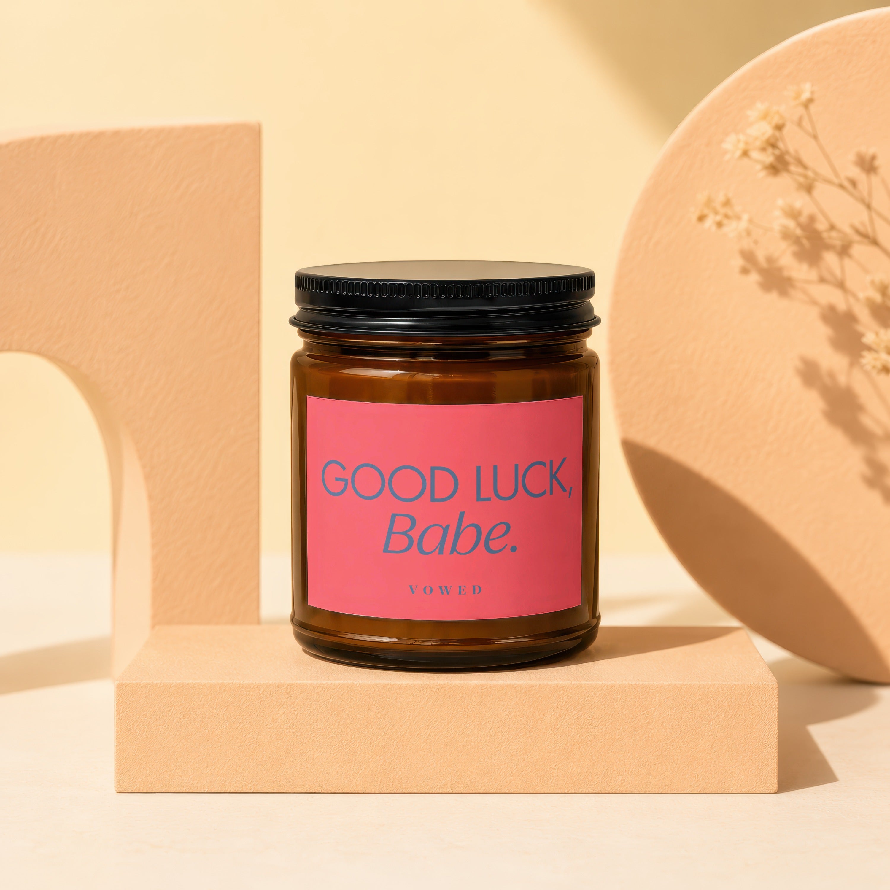 Candle with pink label "Good Luck, Babe." by Vowed.