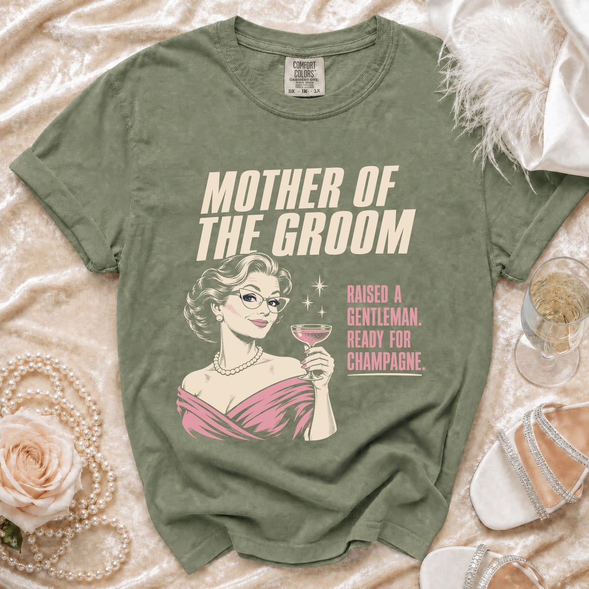 Green t-shirt with "Mother of the Groom Raised a Gentleman Ready for Champagne" text.