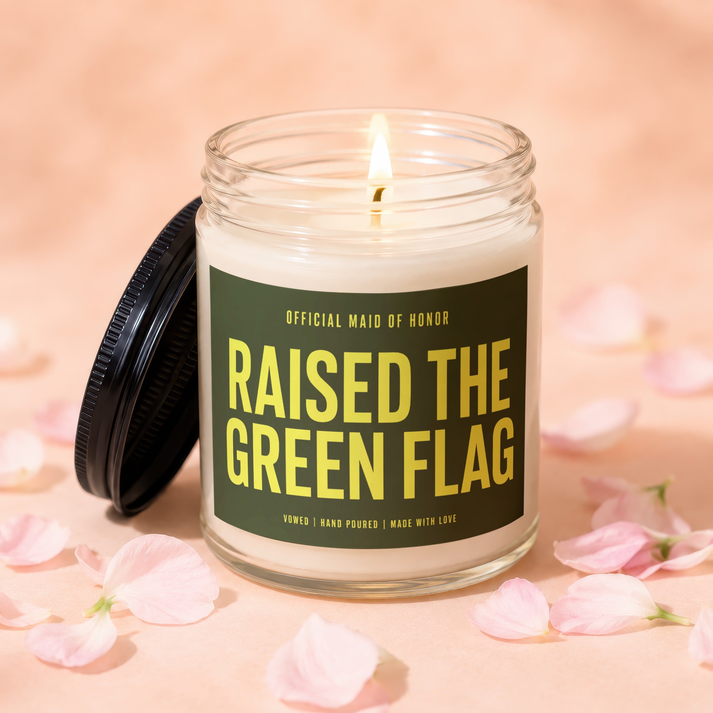 Candle with text "Official Maid of Honor Raised the Green Flag" surrounded by petals.