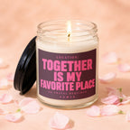 Candle with lit wick, black lid, and label reading "Together is My Favorite Place."