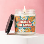 Candle with "HERE'S TO LOVE! FROM YOUR BIGGEST FANS" text and floral design.