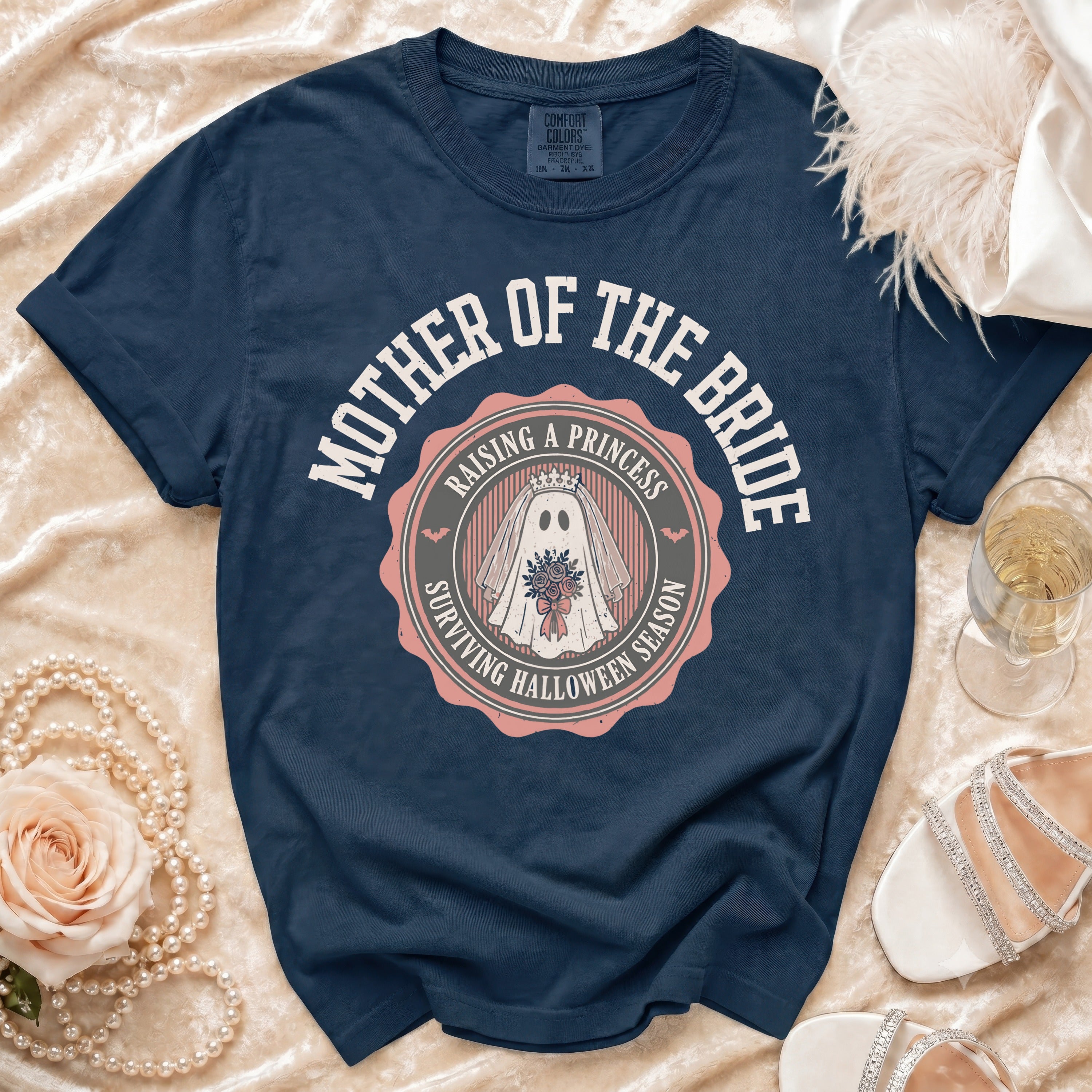 Navy t-shirt with "Mother of the Bride Raising a Princess Surviving Halloween Season" graphic.