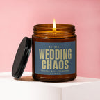 Amber glass candle burning, showing 'Wedding Chaos' label with champagne text.