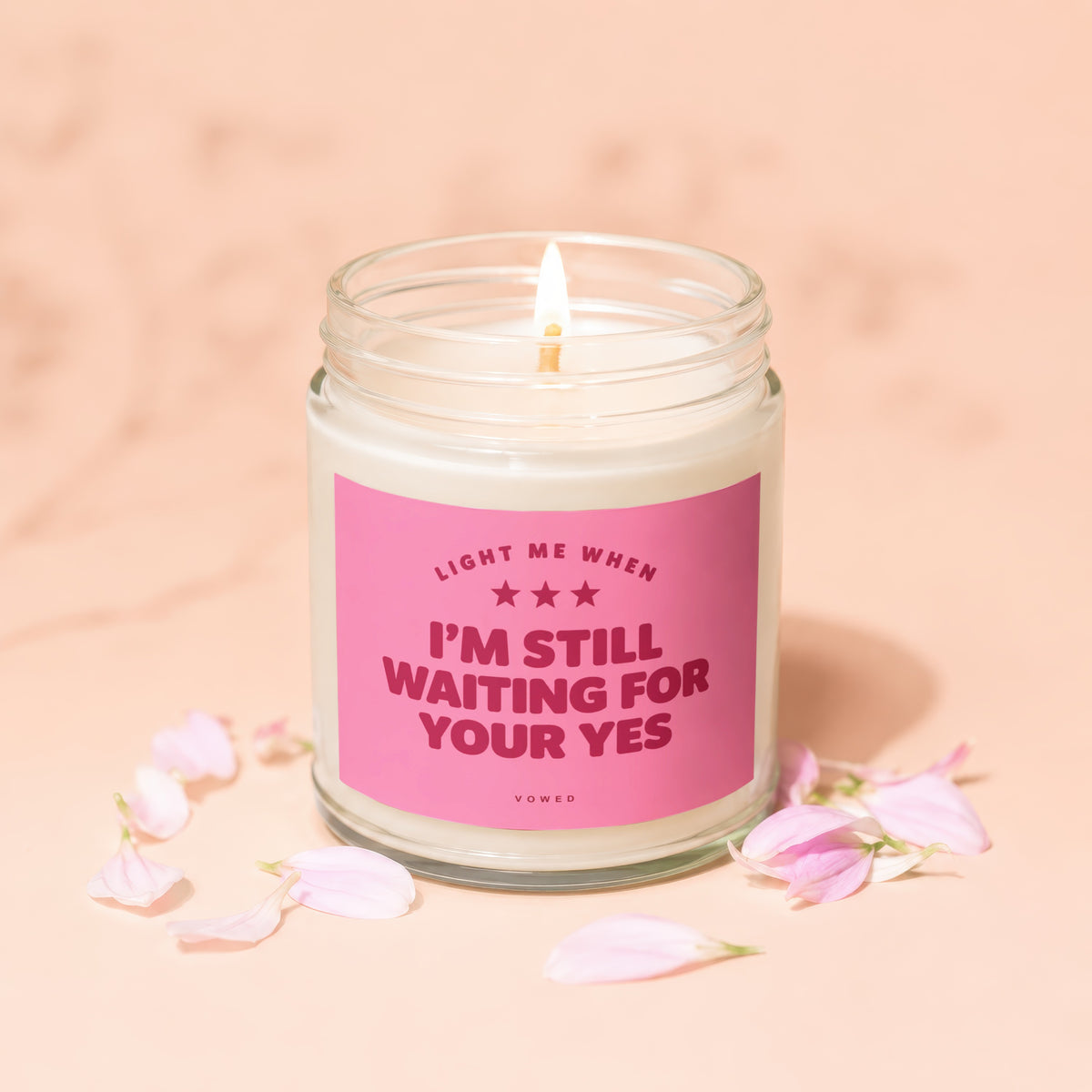 Jar candle with pink label reading "I'M STILL WAITING FOR YOUR YES".