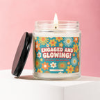 Glass candle with retro flower label reading "ENGAGED AND GLOWING! WITH ALL THE SPARKLE"
