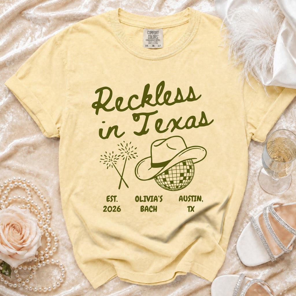 Yellow t-shirt with "Reckless in Texas" and "Olivia's Bach Austin, TX" text.