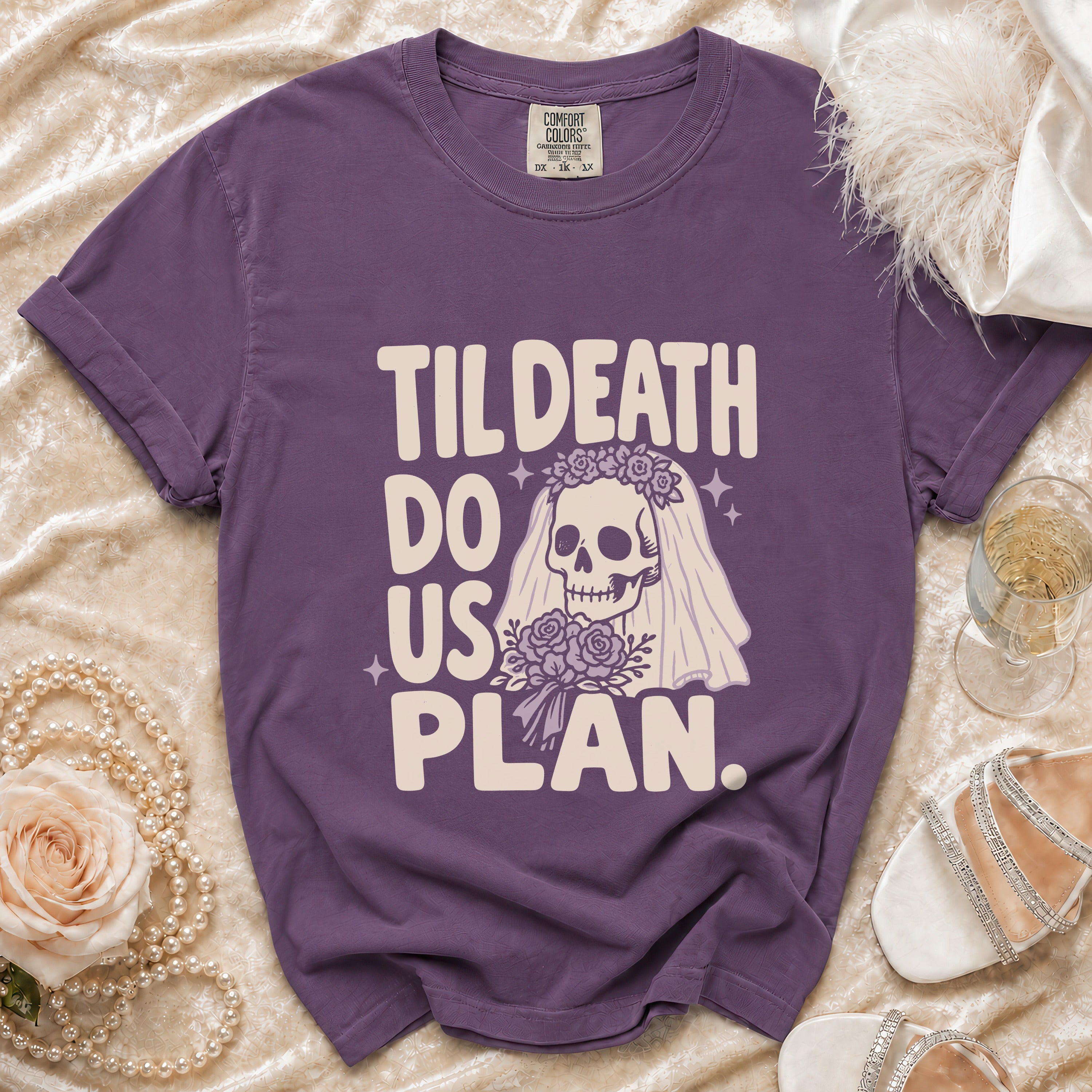 Purple t-shirt with "Til Death Do Us Plan" text and skeleton bride graphic.
