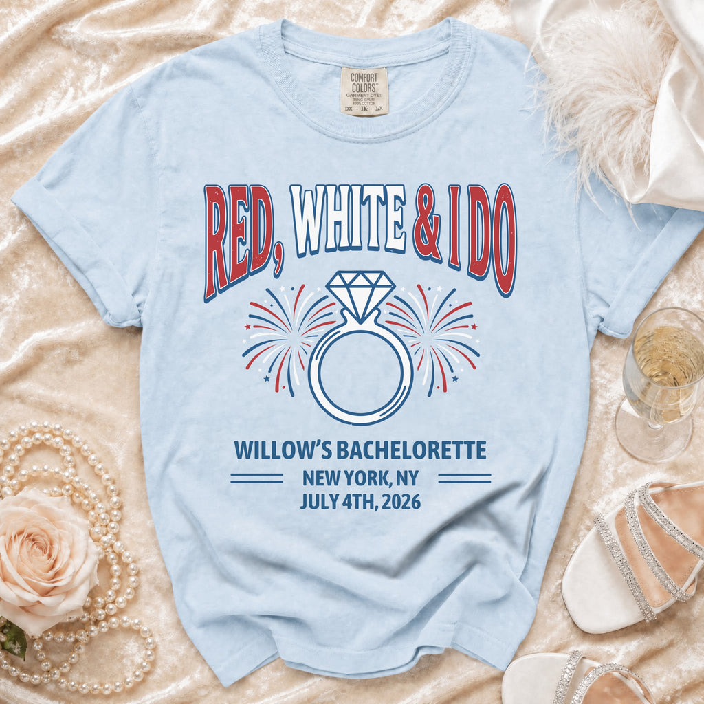 Light blue t-shirt with "RED, WHITE & IDO" text and engagement ring graphic.