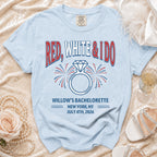 Light blue t-shirt with "RED, WHITE & IDO" text and engagement ring graphic.