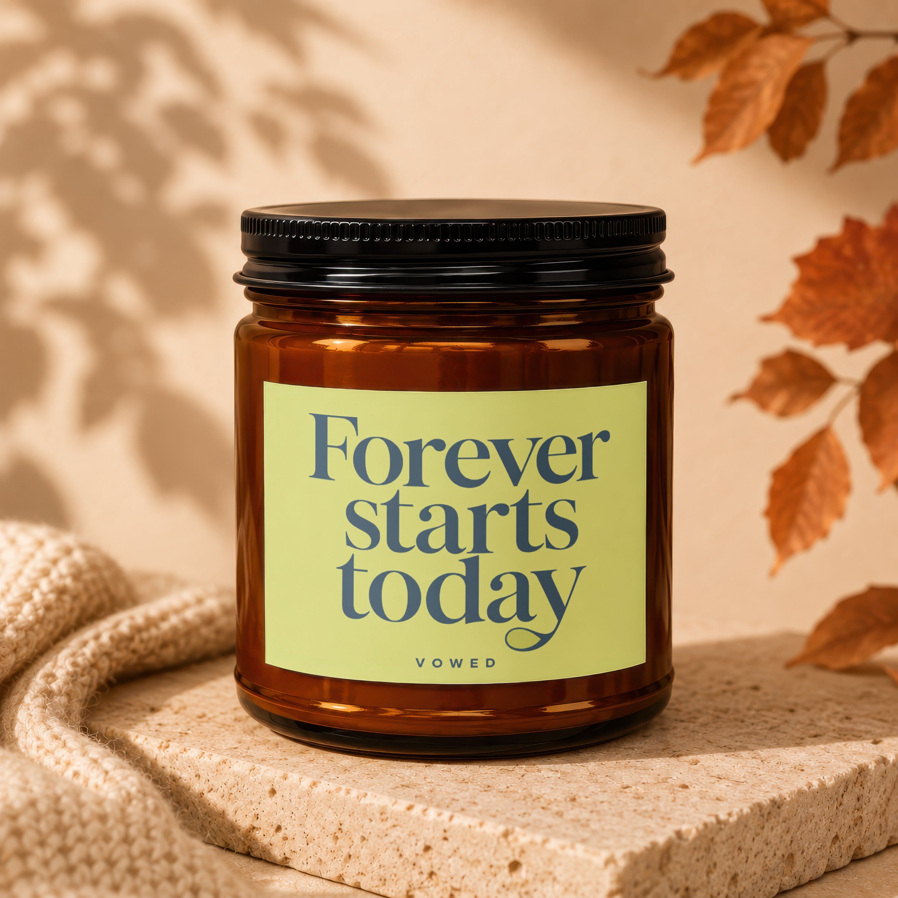 Amber glass candle with "Forever starts today" text on a pale green label.