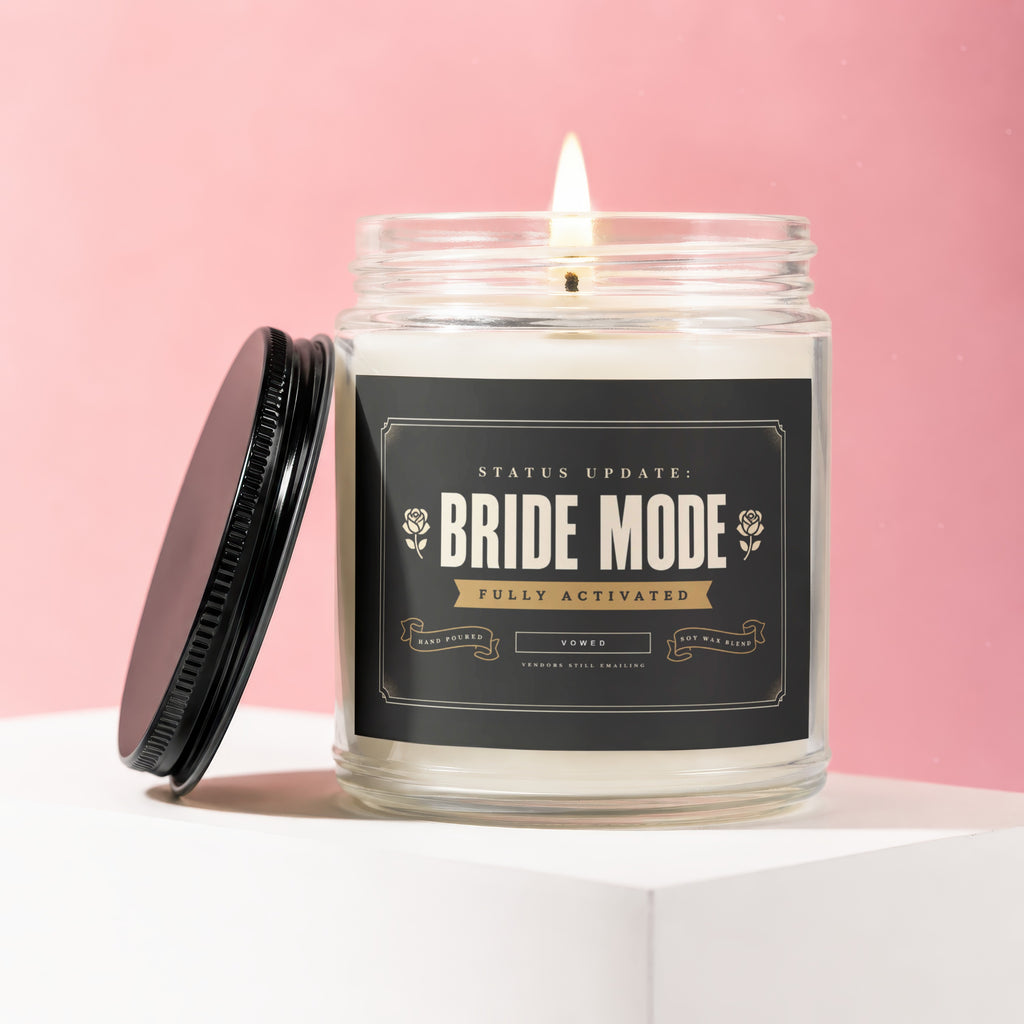 Bride Mode candle with "Fully Activated" text on black label, burning wick.