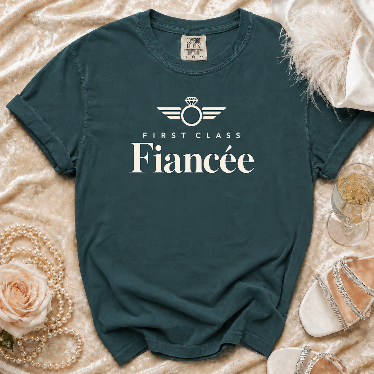 Dark teal t-shirt with "First Class Fiancée" and ring graphic.