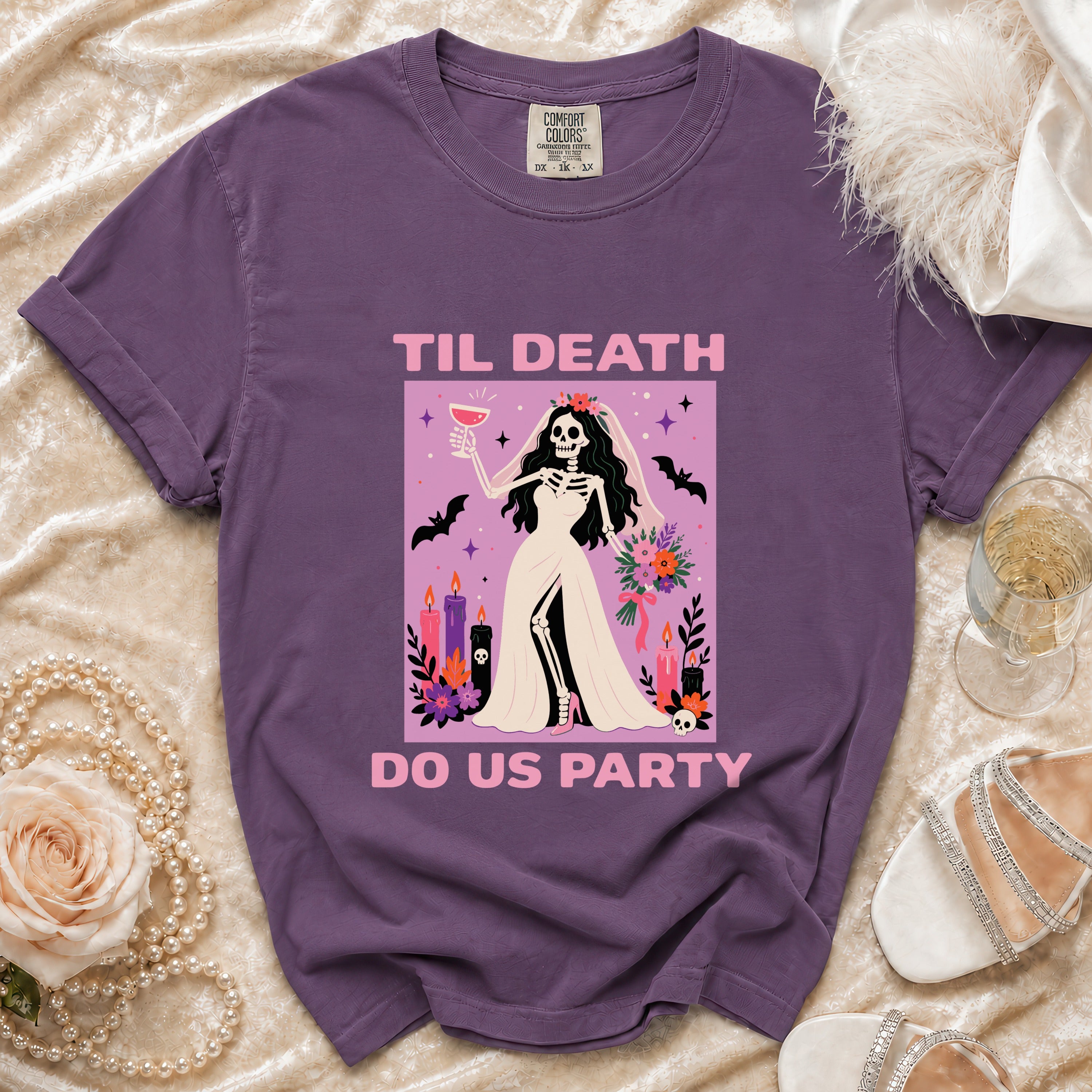 Purple t-shirt with skeleton bride graphic that reads "Til Death Do Us Party".