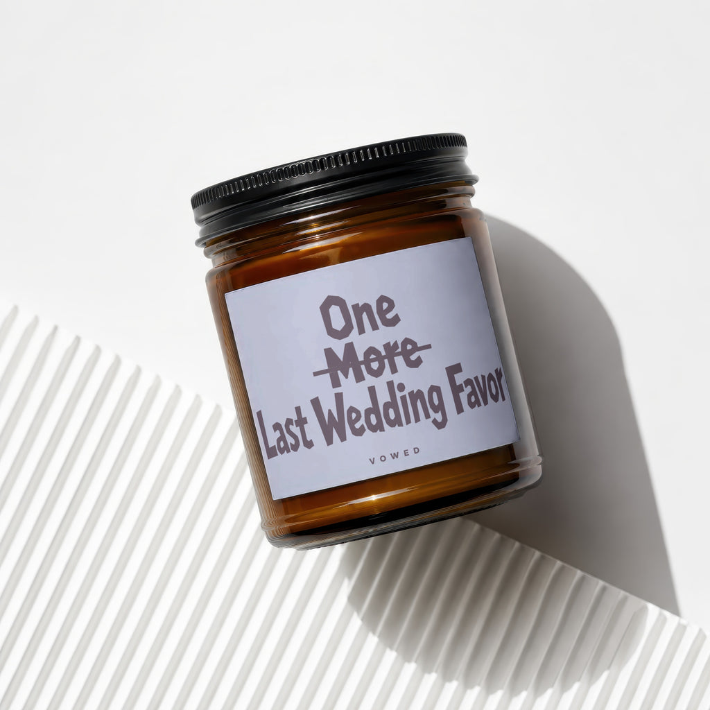 Candle with text "One More Last Wedding Favor Vowed" on label.