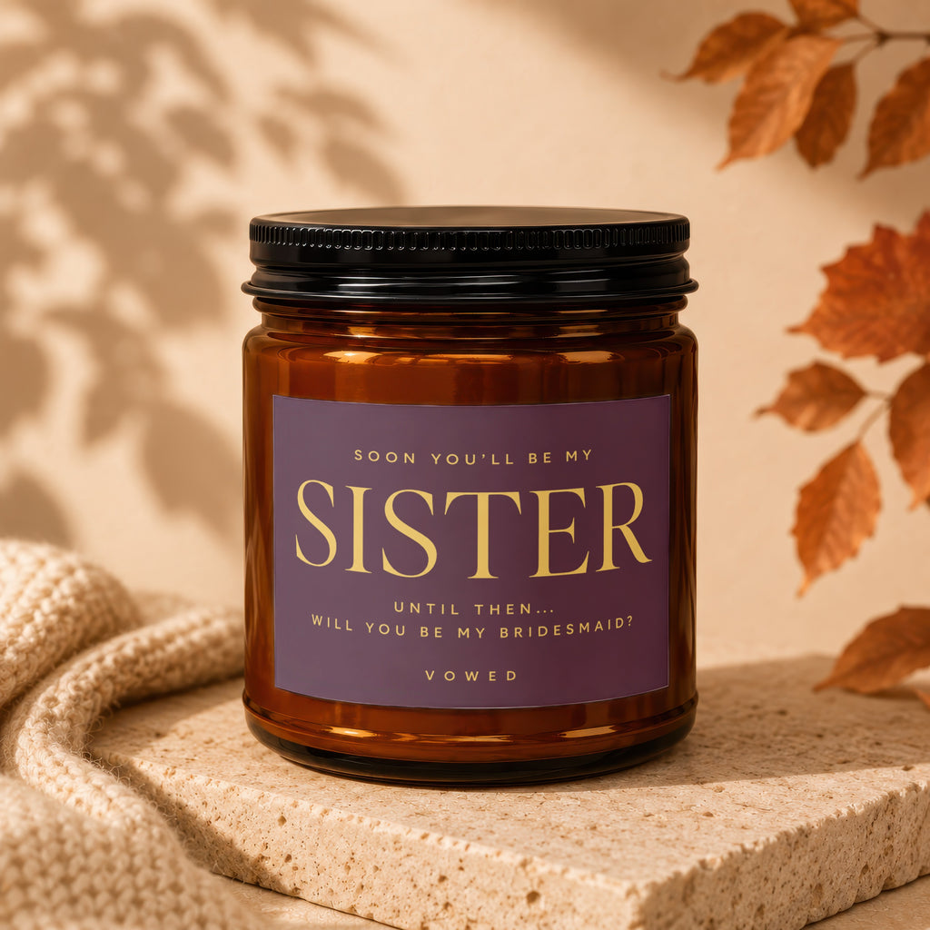 Amber candle with purple label asking "Will you be my bridesmaid?"