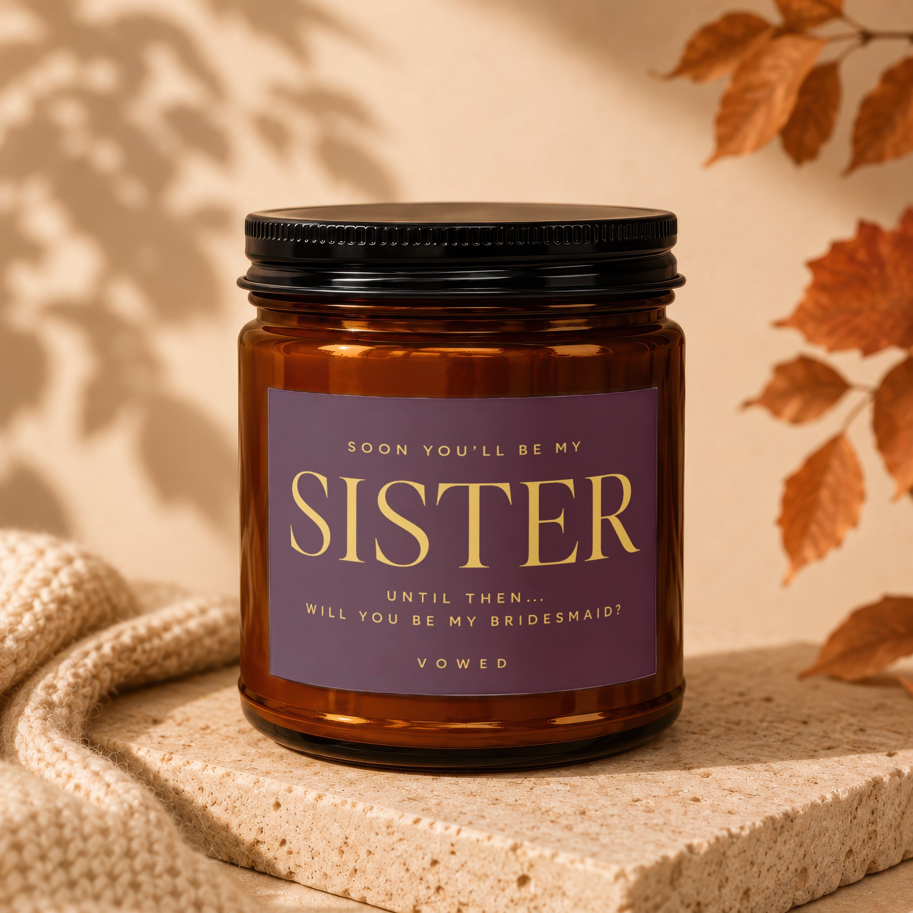 Amber candle with purple label asking "Will you be my bridesmaid?"