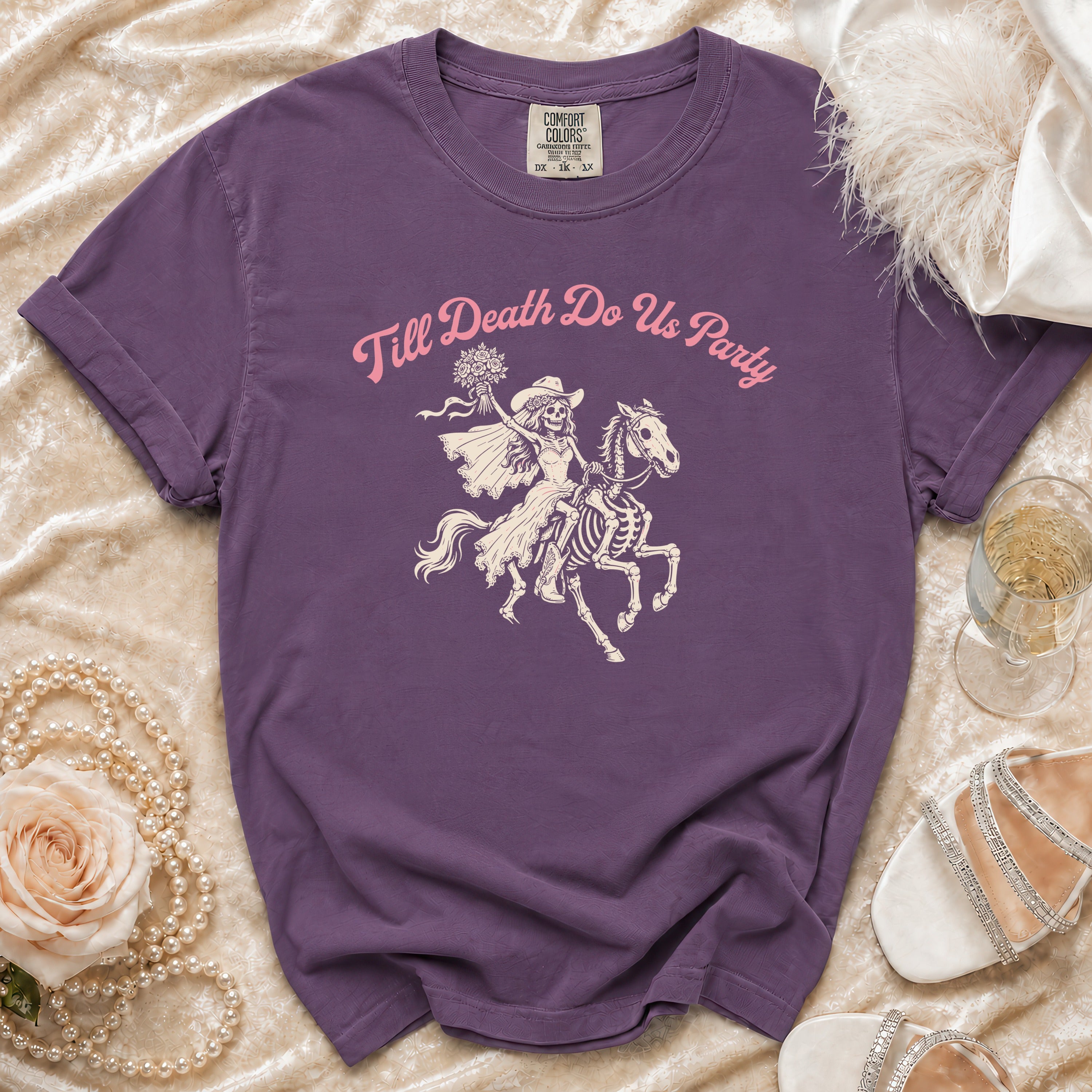 Purple t-shirt with "Till Death Do Us Party" text and skeleton bride on a horse graphic.
