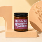 Amber jar candle with burgundy label that reads "Here for the gay agenda (a wedding)"