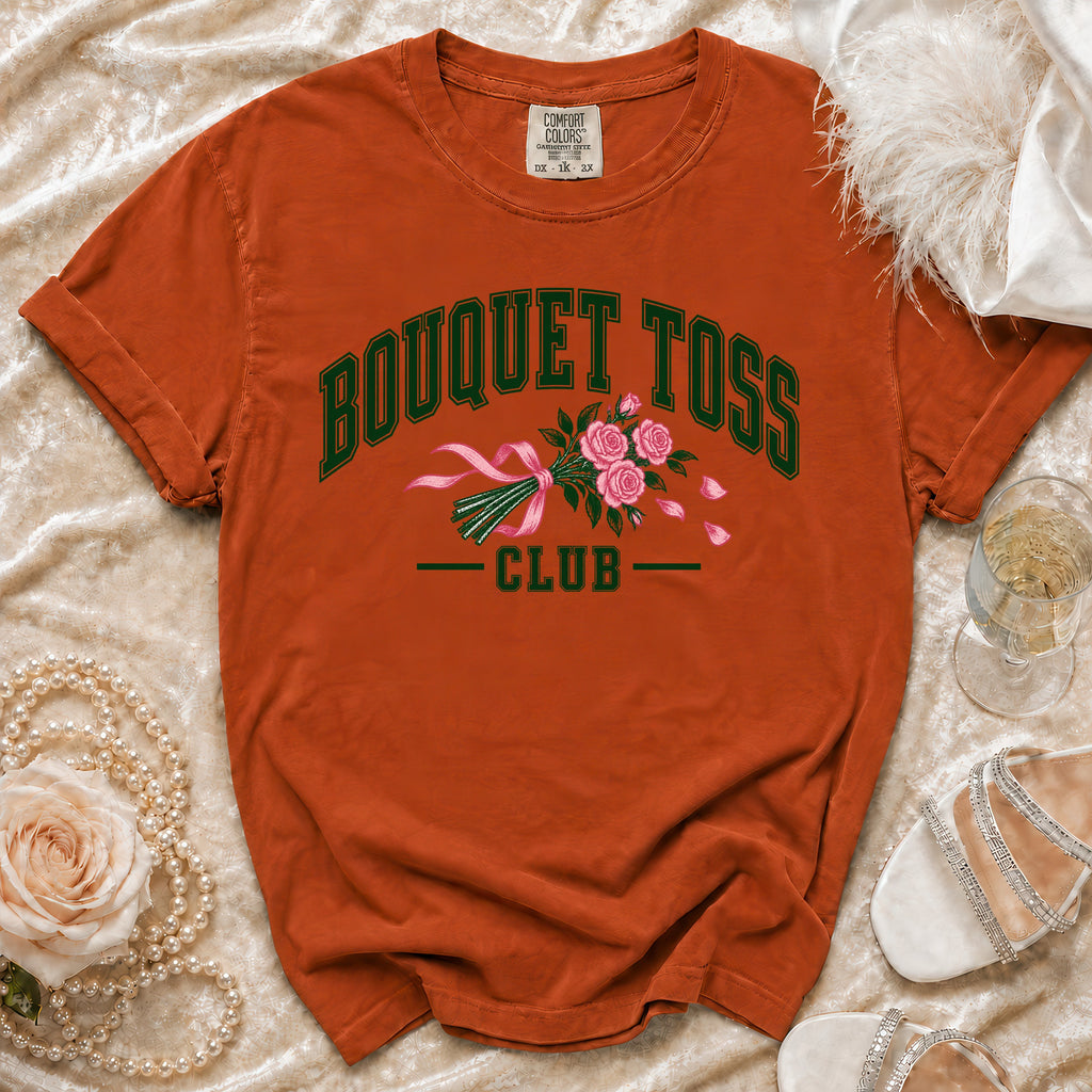 Orange t-shirt with "BOUQUET TOSS CLUB" text and pink roses graphic.