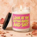 Glass jar candle with pink label reading "Look At You Getting Married and Shit".