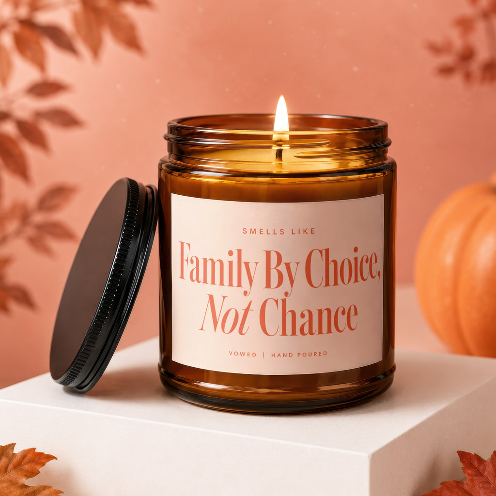 Amber jar candle with lit flame, "Family By Choice, Not Chance" text.