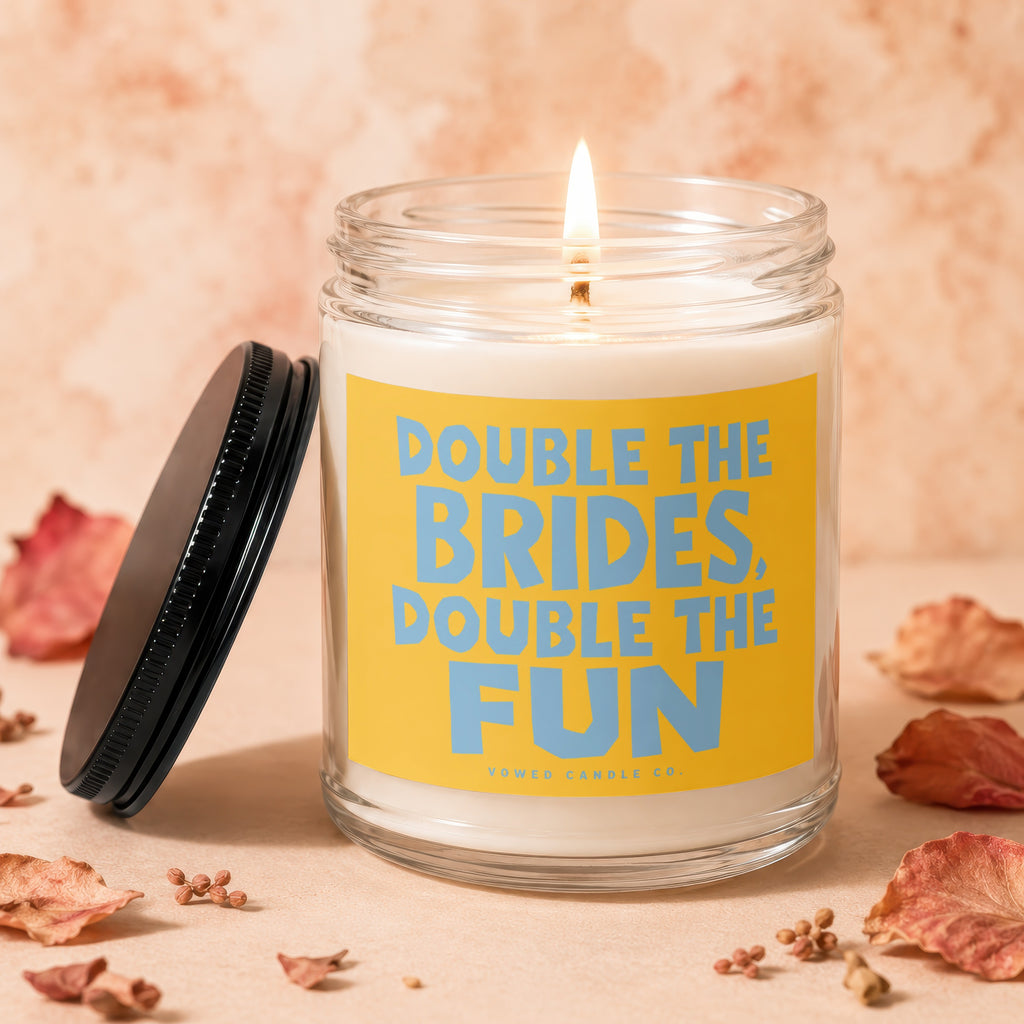Candle with text "Double the Brides, Double the Fun" on yellow label.