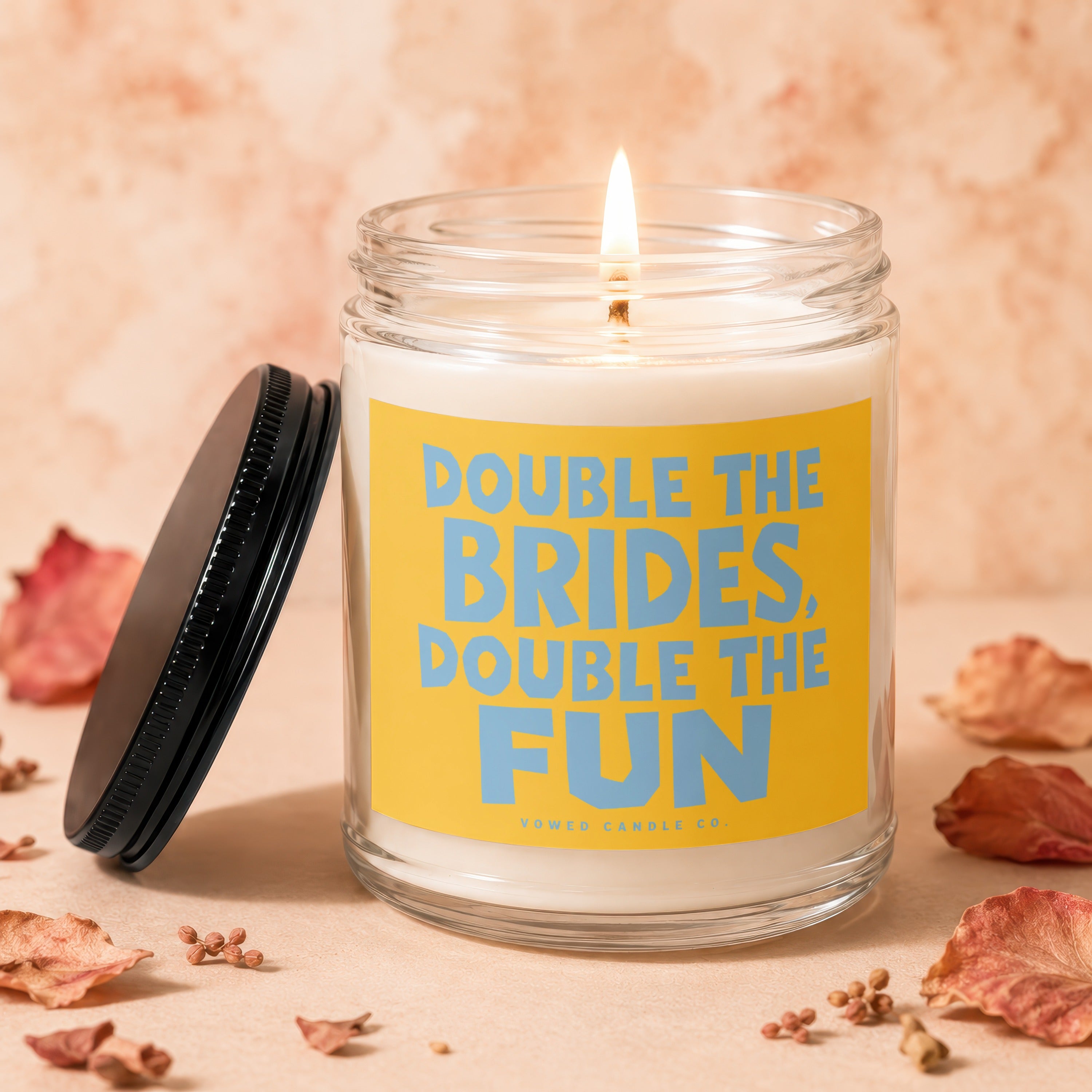 Candle with text "Double the Brides, Double the Fun" on yellow label.
