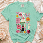 Mint t-shirt with spooky bride, ghost, cat, and Halloween-themed graphics.